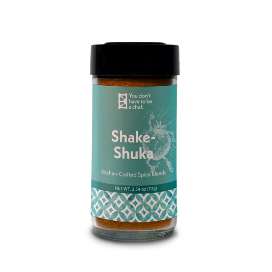 A bottle of Shake-Shuka spice blend for enhancing the flavors of tomato sauce in Shakshuka, with a mix of Mediterranean spices.